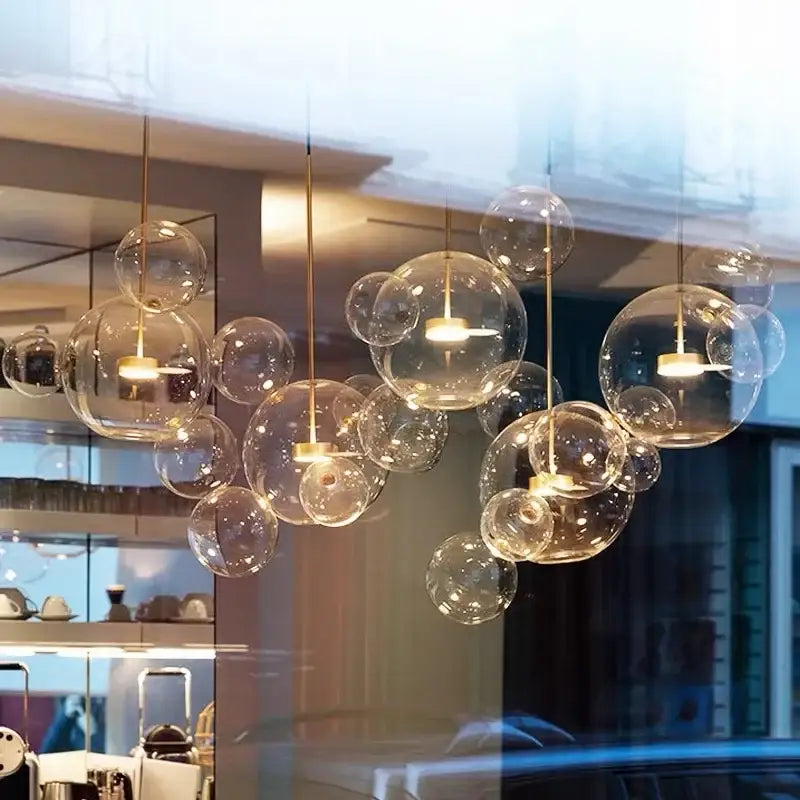 Art deco glass bubble chandelier with clear glass bubble pendant lights and warm golden fixtures for dining room decorbites art deco