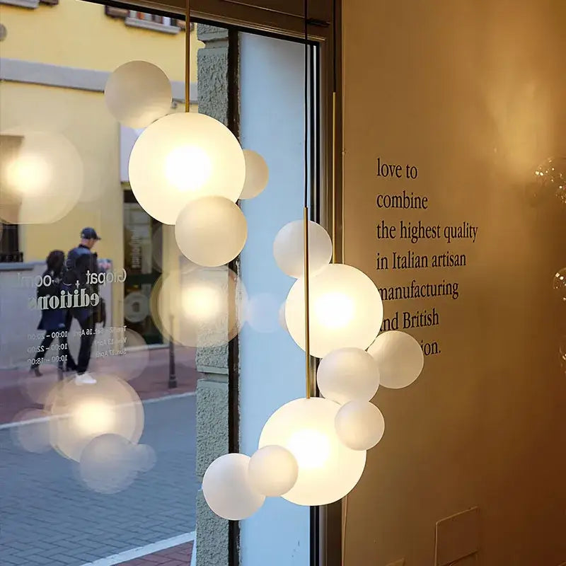 Modern art deco glass bubble chandelier with frosted glass orbs in a cascading cluster for dining room decorbites lighting