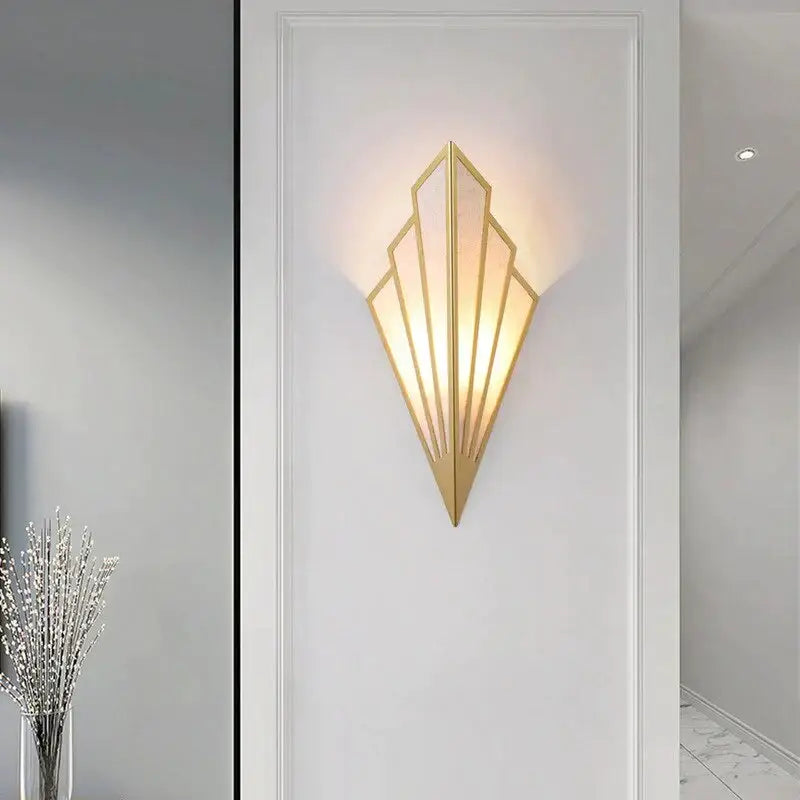 Art deco gold diamond shape modern wall light with geometric fan design and frosted glass panels for bedroom use