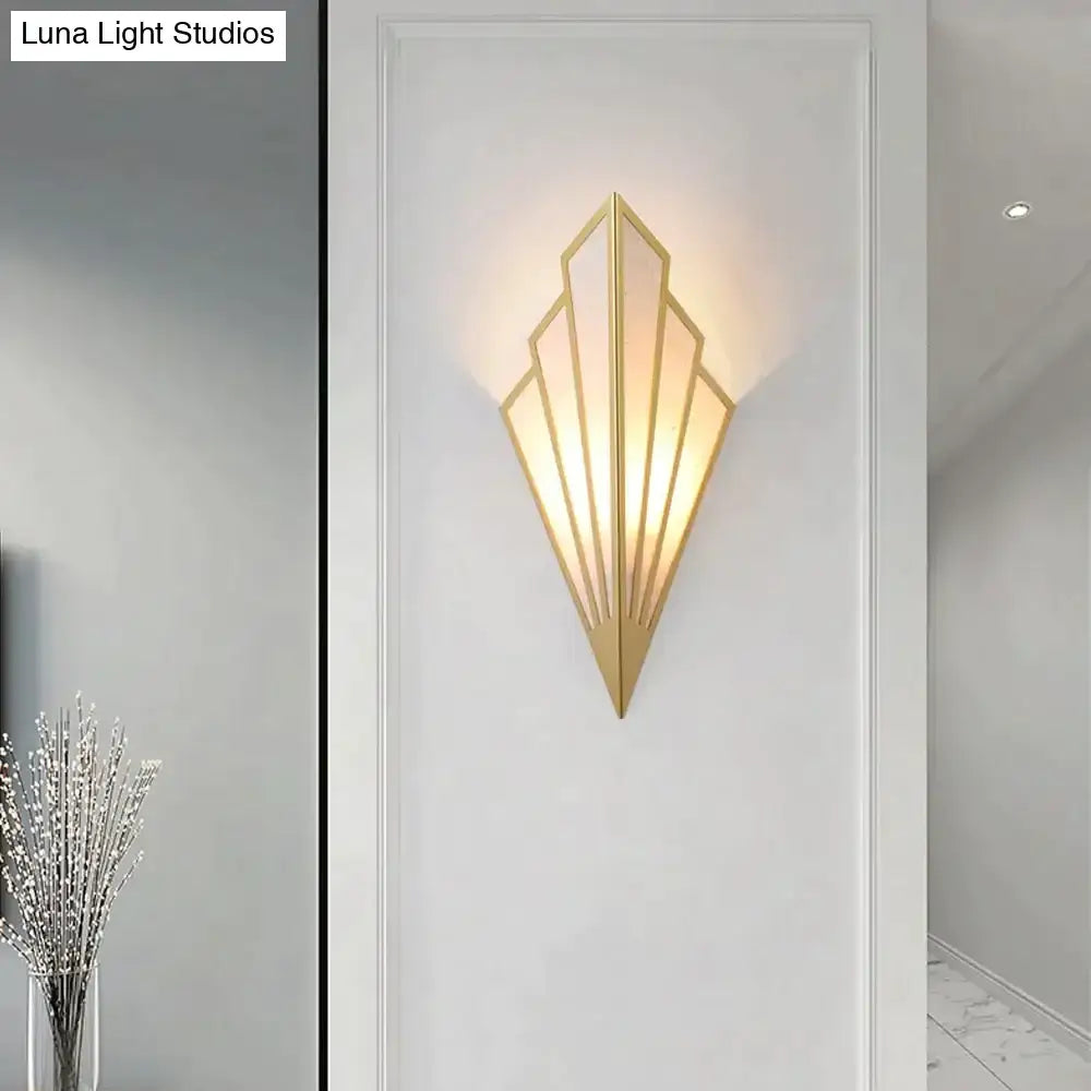 Gold-toned art deco wall light with diamond shape modern design and warm ambient lighting for bedroom use
