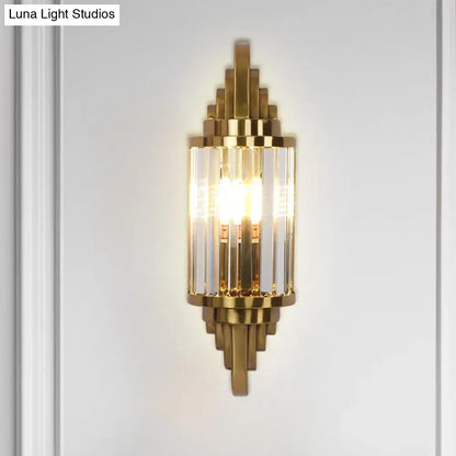 Art deco gold finish wall light with crystal prisms and geometric brass accents for elegant living room decor