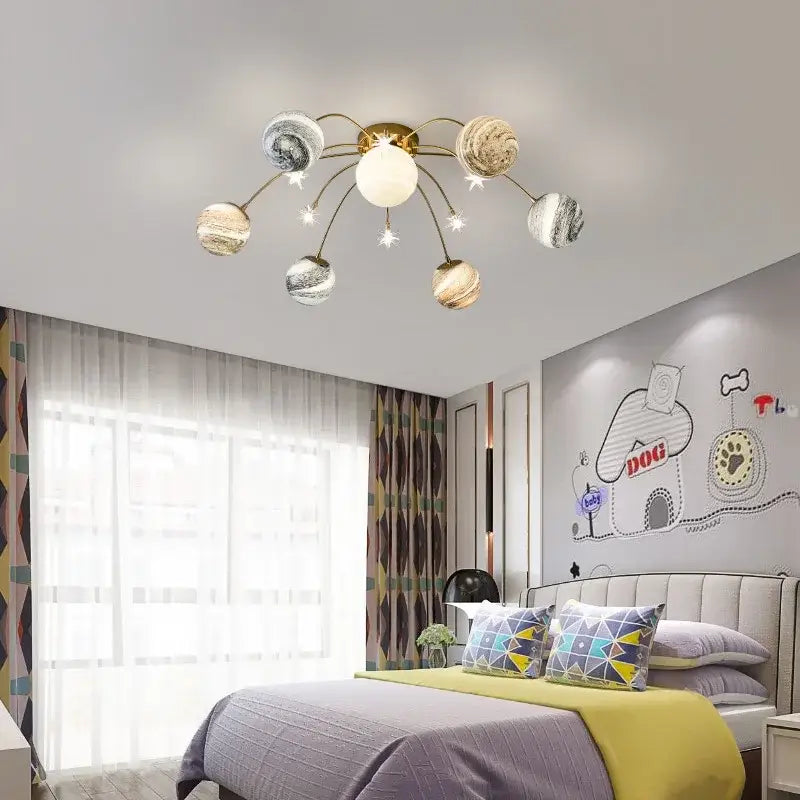 Gold-toned decorbites art deco planet ball pendant lamp with six swirling patterned globes and central spherical bulb for dining room