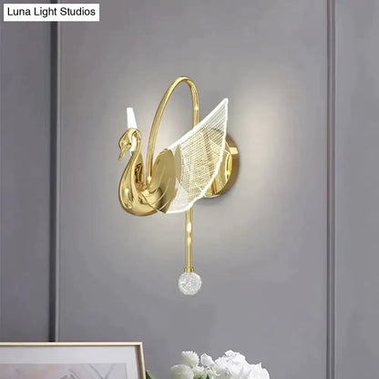 Art deco gold wall lamp shaped like a swan with translucent mesh wing and crystal orb for bedroom bedside wall use