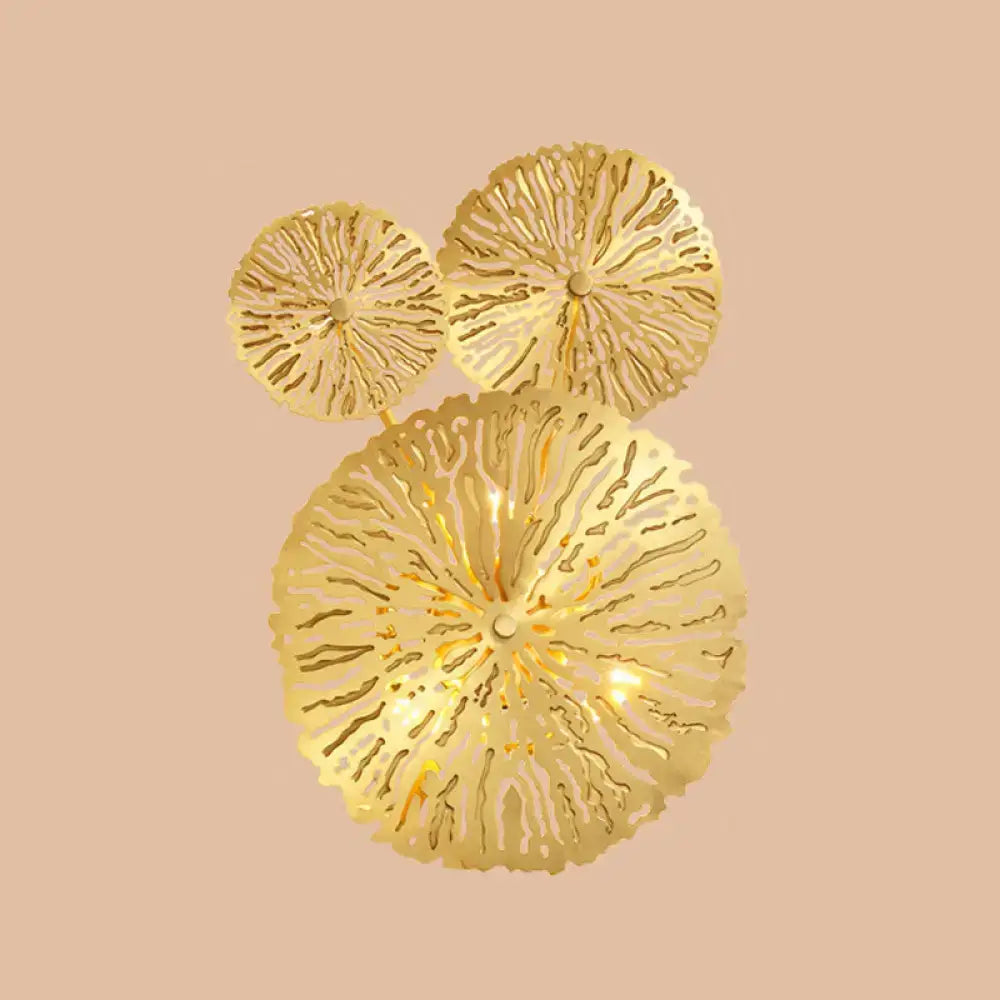 Golden intricately cut coral metal art deco wall mount light fixture with three circular tiers for bedroom sconce