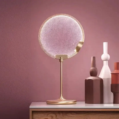 Circular vanity mirror with frosted glass and gold metallic frame complementing decorbites glass horo led pendant light