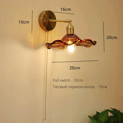 Gold-toned decorbites art deco led wall lamp with wavy amber glass shade and brass hardware for bedroom decor