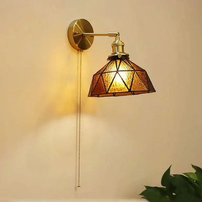 Vintage-style brass art deco led wall lamp with geometric amber stained glass shade by decorbites for bedroom decor