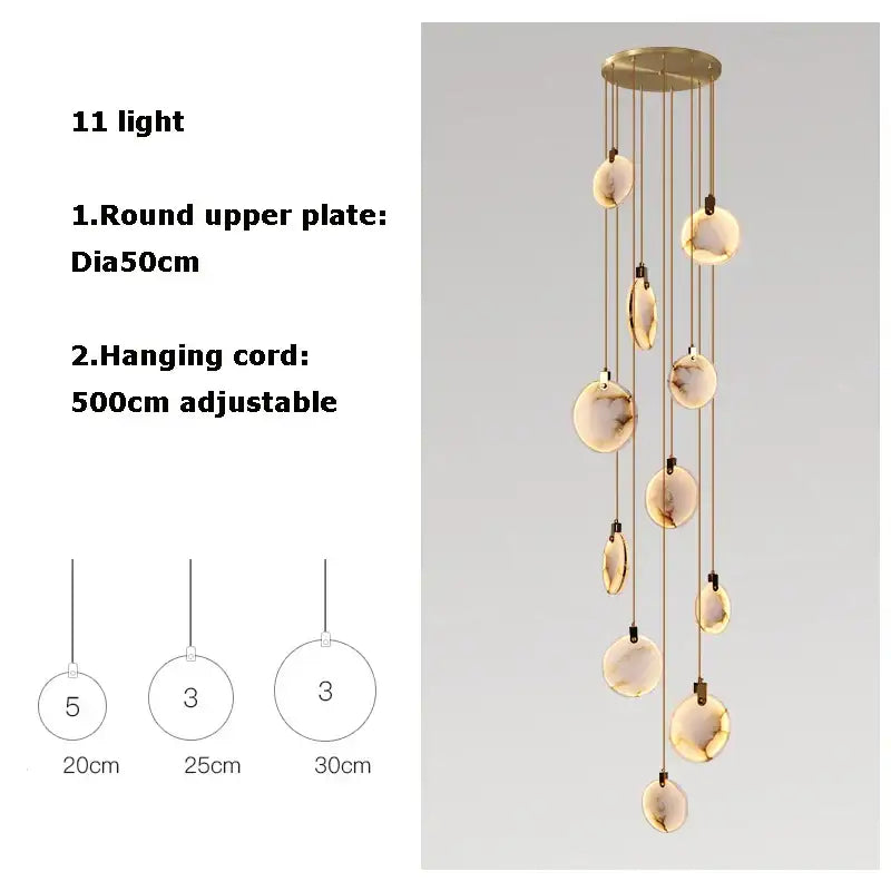 A modern art deco marble golden lustre pendant light with eleven amber glass orbs for dining room use