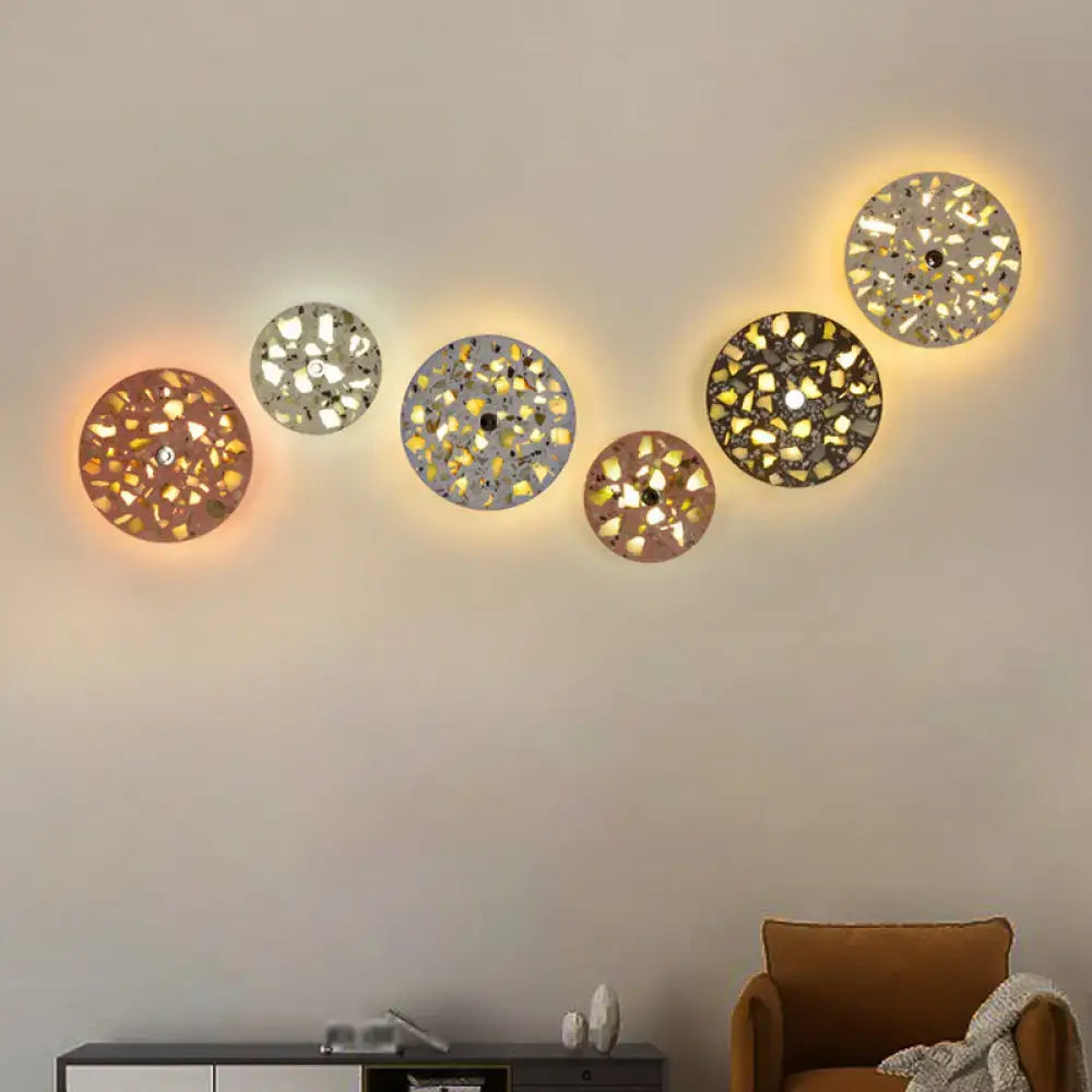 Set of five art deco mosaic terrazzo led wall lights with warm glowing light and textured concrete finish for living room wall sconce