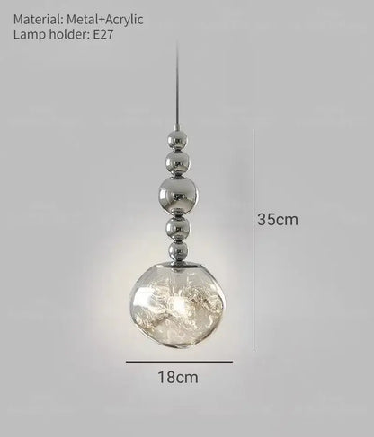 Art deco silver lava pendant light featuring a silver beaded frame with textured acrylic globe and led bulb suitable for living room