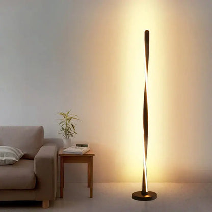 Modern twisted gold floor lamp with sleek art deco design and warm ambient lighting from decorbites art deco collection