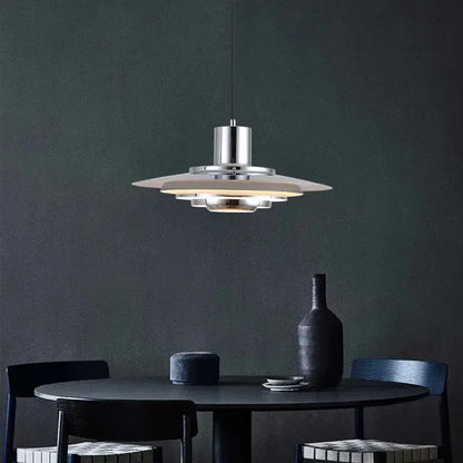 Art deco pendant light with chrome finish and layered translucent white aluminum shades for dining room use