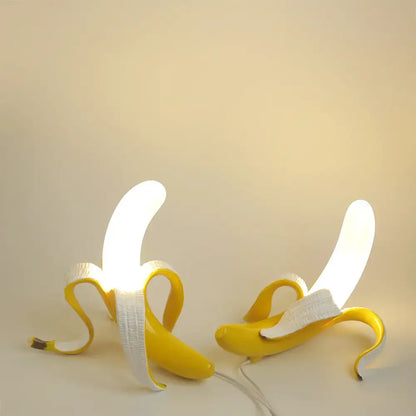 Two illuminated yellow banana-shaped lighting fixtures with decorbites glass lampshade led for bedroom decor