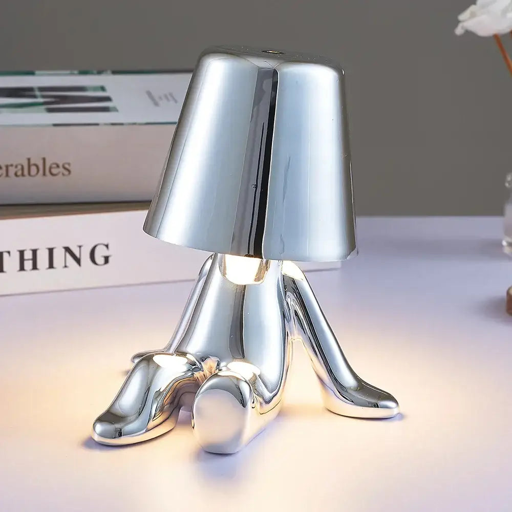 Shiny chrome-plated articulated man table lamp with inverted conical shade ideal as a bedroom night light