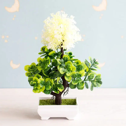 Artificial bonsai tree with lush green leaves and fluffy white flower crown in a sleek white rectangular pot
