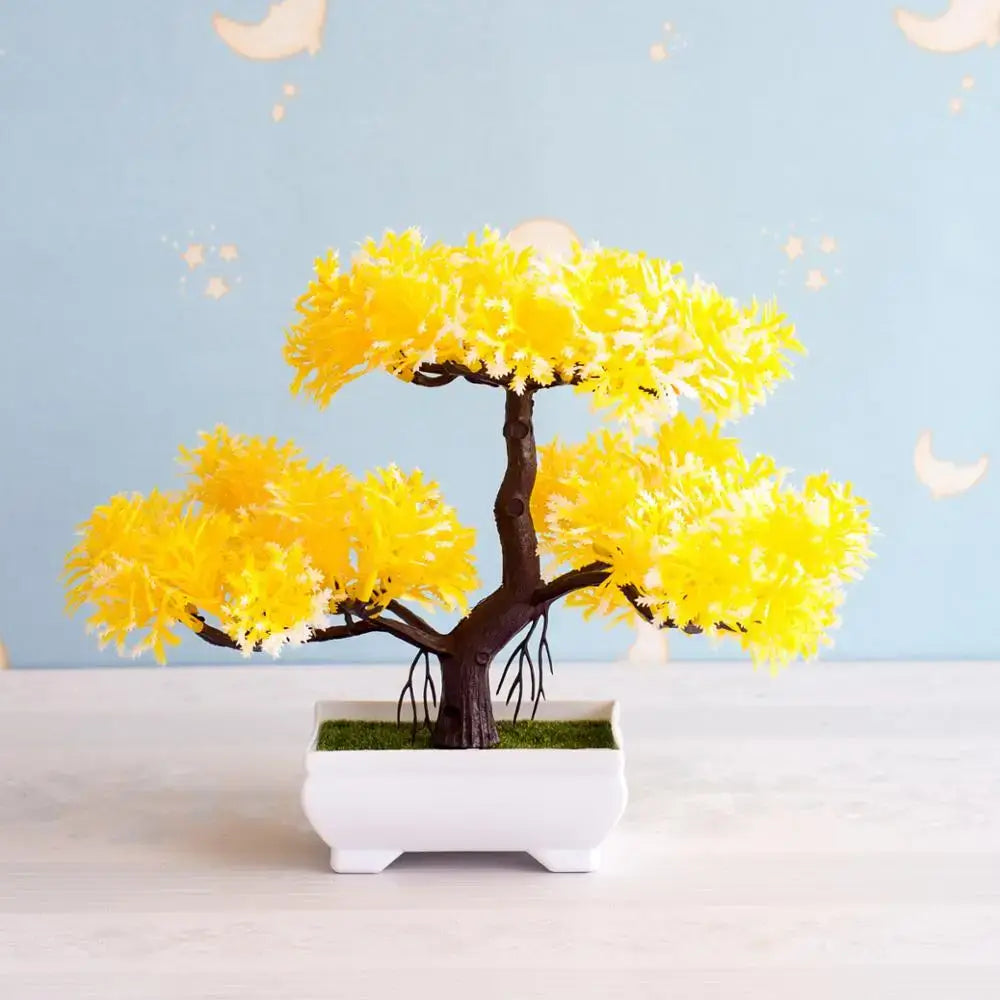 A vibrant yellow artificial bonsai tree with dark brown trunk in white ceramic pot with green moss for decor