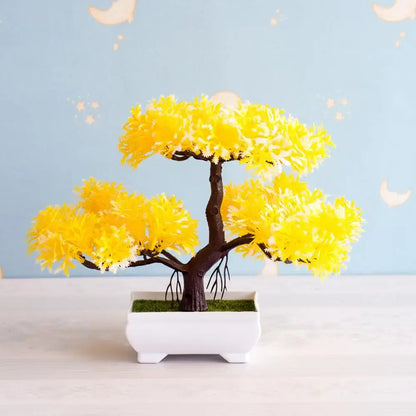 A vibrant yellow artificial bonsai tree with dark brown trunk in white ceramic pot with green moss for decor