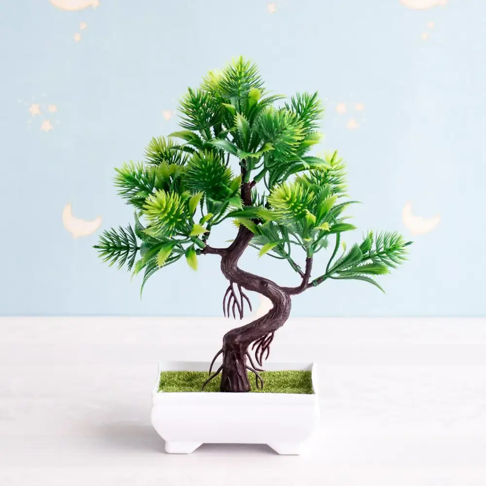 Artificial bonsai tree with dark brown twisted trunk and vibrant green foliage in white rectangular pot with faux moss