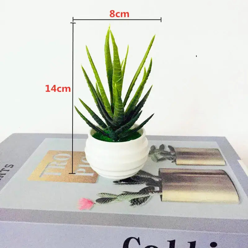 A small artificial bonsai tree with green aloe vera leaves in a white ceramic pot for garden decor