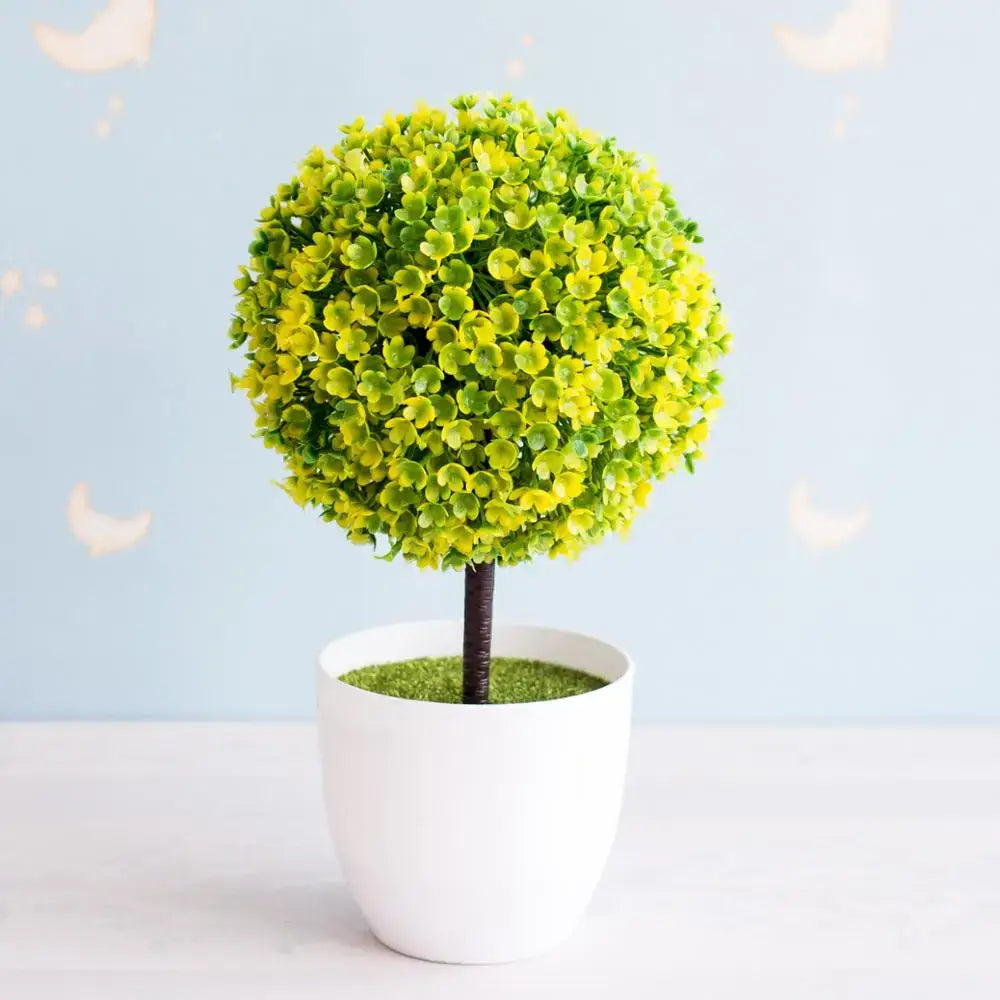 A round artificial bonsai tree with vibrant green and yellow leaves in a white ceramic pot for garden decor