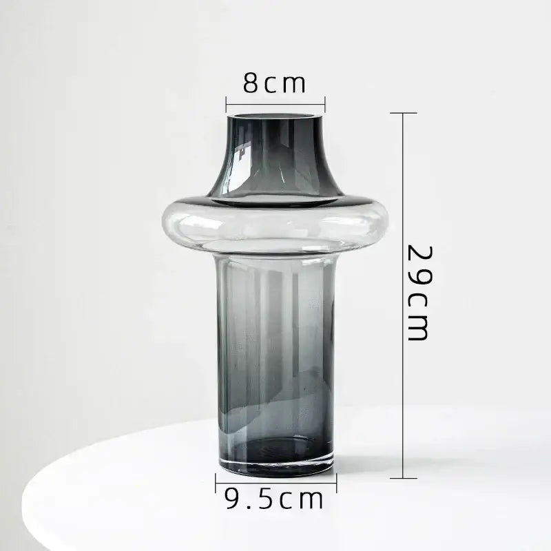 Artisan glass vase with a sleek modern design featuring clear to dark gray gradient and an elegant flared neck