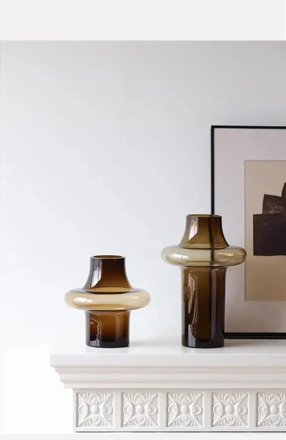 Two amber-colored artisan glass vases with smooth rounded bands and tapered necks for elegant decor
