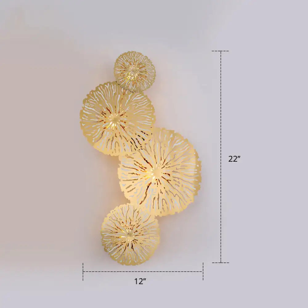 Artistic golden lotus leaf sconce light fixture with a gold-toned textured circular wall art design for living room use