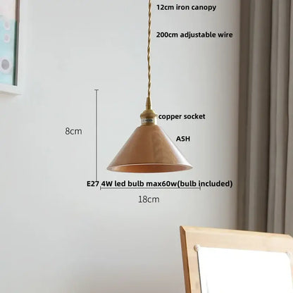 A warm-toned copper conical pendant lamp with brass-finished iron canopy and adjustable wire for decorbites ash wood settings