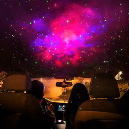 A sleek white and gold decorbites astronaut sky projector nightlight casting a vibrant nebula with green stars inside a car