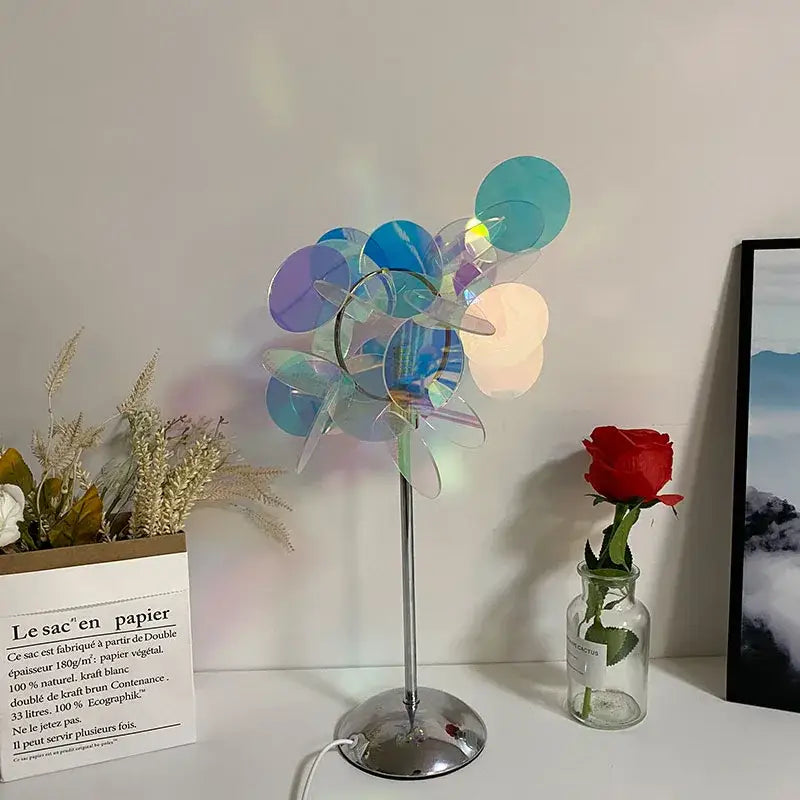 A modern aurora acrylic projection lamp with multi-colored paper disc shade blue and purple tree bedroom night light