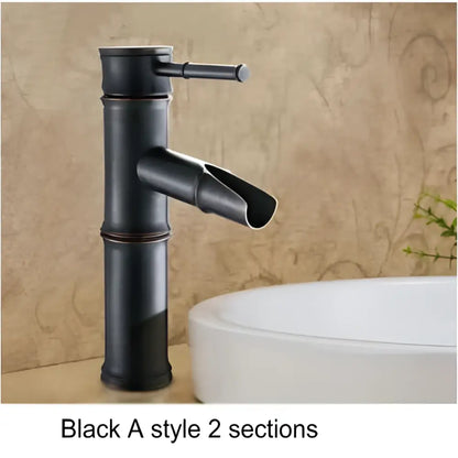 Black bamboo style basin mixer tap with matte finish and segmented design in antique brass and black for bathroom use