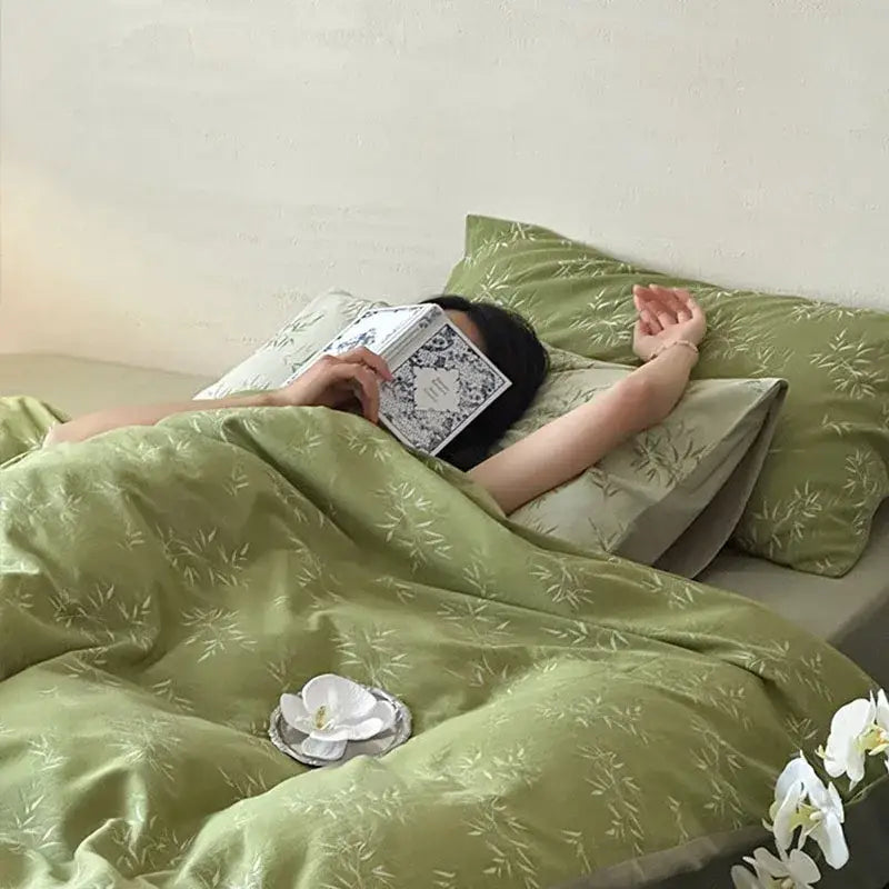 Olive green bamboo leaf jacquard cotton bedding set with matching pillows and white orchid decor for bedroom quilt set