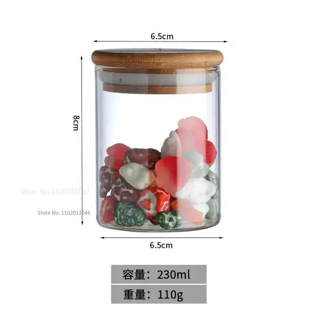 Clear glass food storage jar with bamboo lid containing colorful heart-shaped stones for kitchen spice set