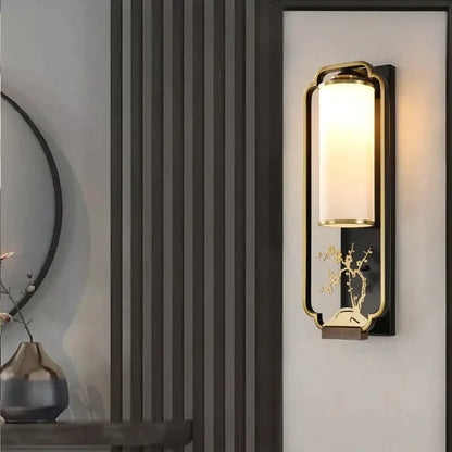 Gold-toned iron glass wall lamp with frosted glass cylinder and carved bamboo motif for bedroom or living room decorbites iron glass wall
