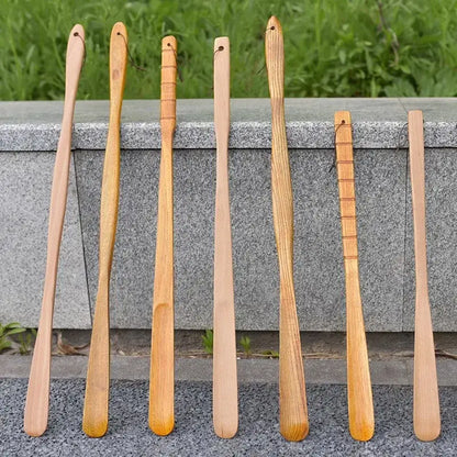 Set of seven natural wood long handle shoe lifters with bamboo pattern and grooved handles for bedroom dressing aid
