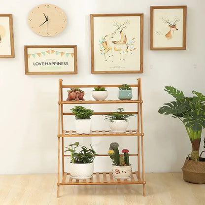 Decorbites™ bamboo plant stand organizer shelf with three-tier light wood slatted shelves holding potted plants
