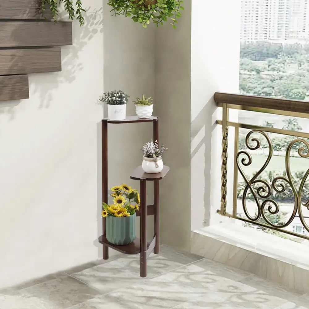 Dark brown bamboo tall corner plant stand with three tiered shelves for outdoor garden use by decorbites