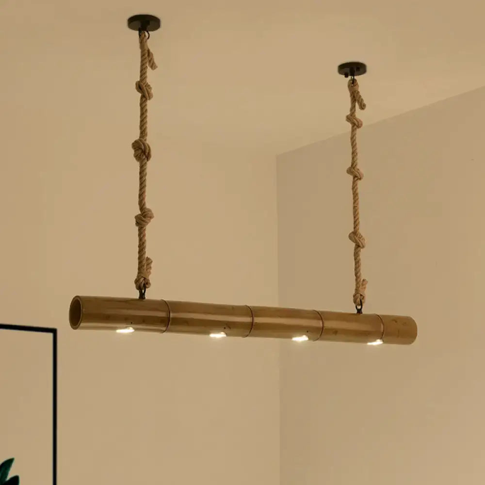A rustic bamboo tube island pendant light with natural tan finish and beige rope featuring three led bulbs by decorbites