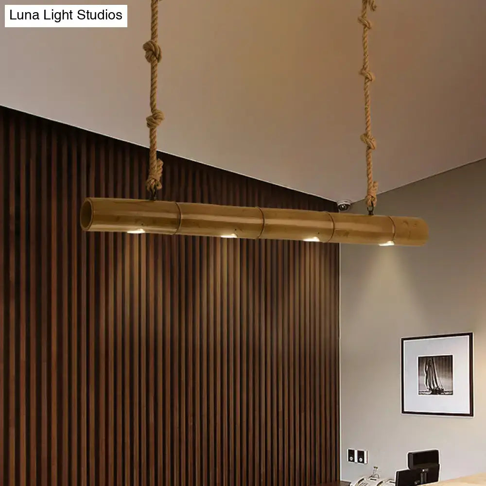 A sleek natural bamboo tube island pendant light with warm golden finish and integrated led lighting by decorbites