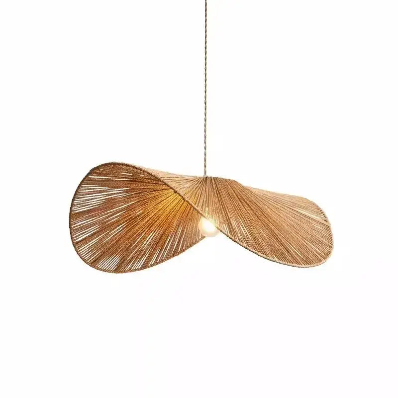 A warm-toned bamboo wabi sabi woven rattan pendant light with a flowing leaf design for dining room use