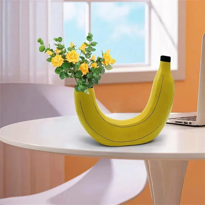 Yellow banana shape resin flower vase with black tip and subtle line detailing made of ceramic material