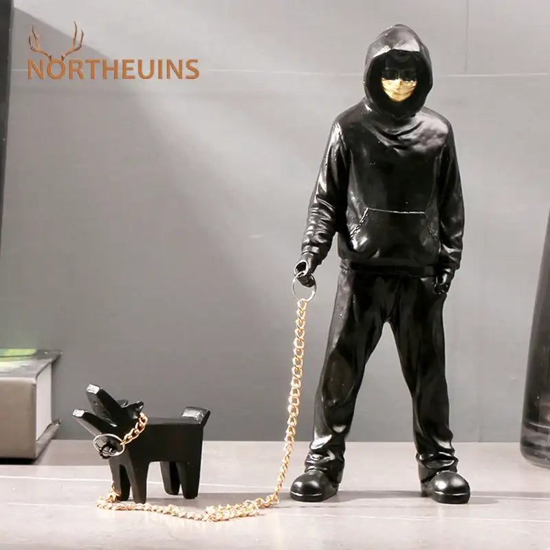 Black resin banksy dog walker figurine with gold face and chain leash walking small black dog for street art decor