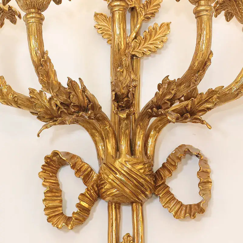 Golden ornate baroque antique brass wall sconce with leaf and ribbon detailing for dining room decorbites baroque antique design