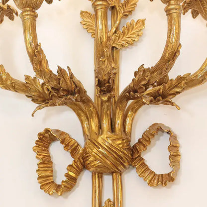 Golden ornate baroque antique brass wall sconce with leaf and ribbon detailing for dining room decorbites baroque antique design