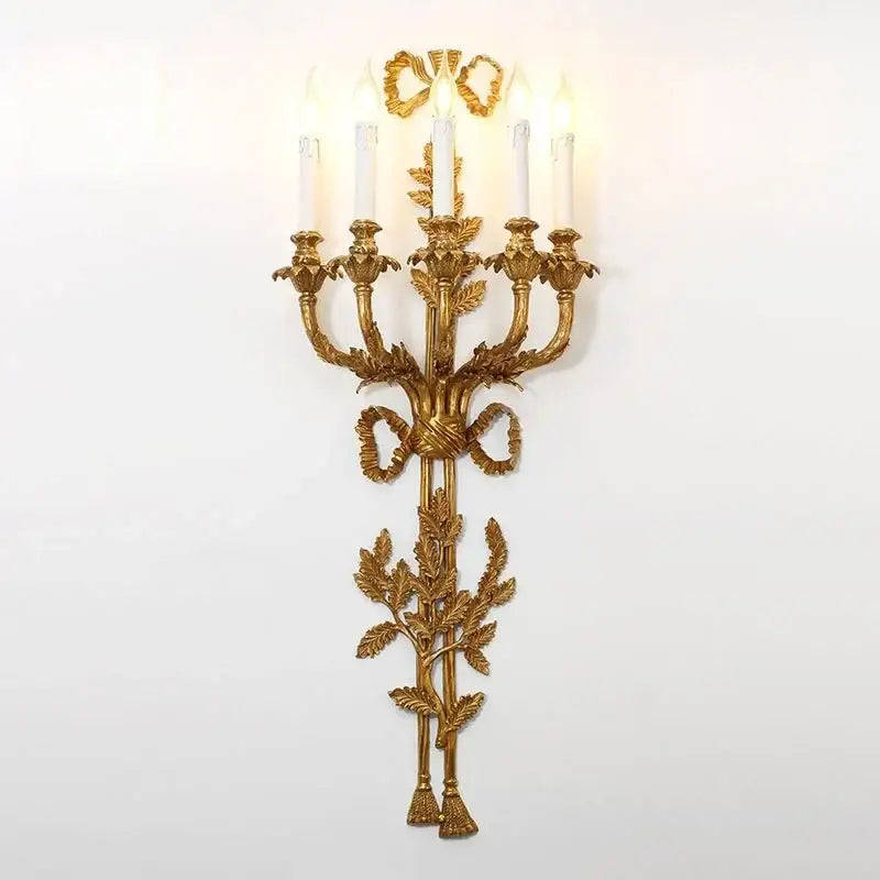 Golden ornate baroque antique brass wall sconce by decorbites with five candle lights and leafy ribbon design for dining room