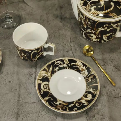 Black and gold ornate porcelain teacup with white interior and decorative handle from black unicorn series kitchenware