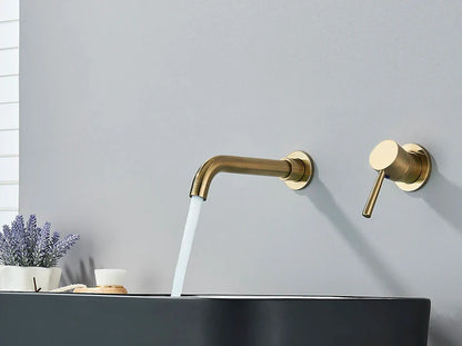 Modern gold-toned basin faucet wall mounted bathroom fixture with brushed brass finish and hot water control flowing stream