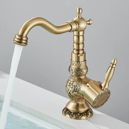 Antique brass single hole basin faucet with ornate floral engravings and curved spout for bathroom vessel sinks