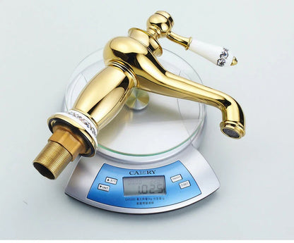 Bathroom faucet bronze finish with gold-finished brass body and white ceramic handle featuring black floral detailing