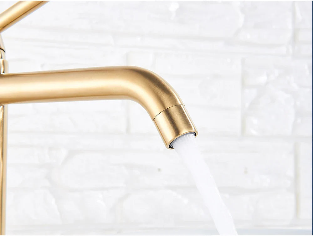 Gold-toned brushed gold bathroom faucet mixer tap with sleek curved spout and flowing water for modern use